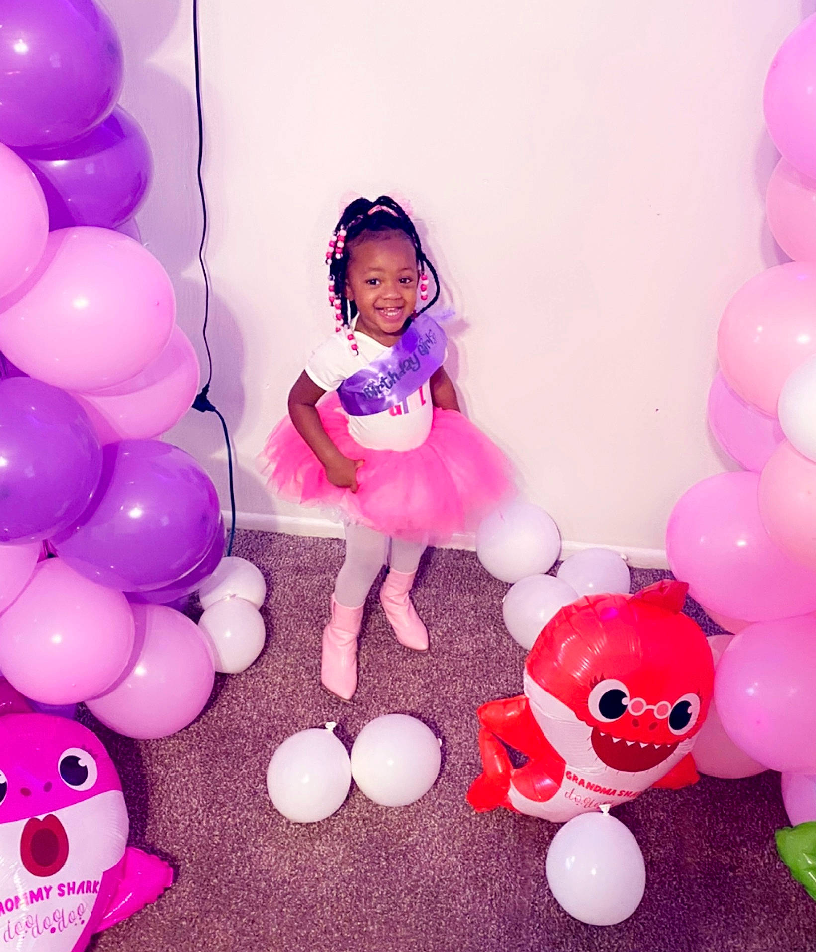Justice is registered to the contest to win money with this photo: baby_toddler_clothing, baby_toys, balloon, child, dress, event, facial_expression, fun, happy, joy, magenta, material_property, organ, party_supply, person, pink, product, purple, smile, toddler
