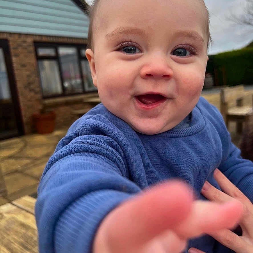 Albie is registered to the contest to win money with this photo: architecture, baby, bodypart, building, clothing, face, finger, hand, happy, head, house, housing, laughing, outdoors, person, photography, portrait, selfie, shelter, smile