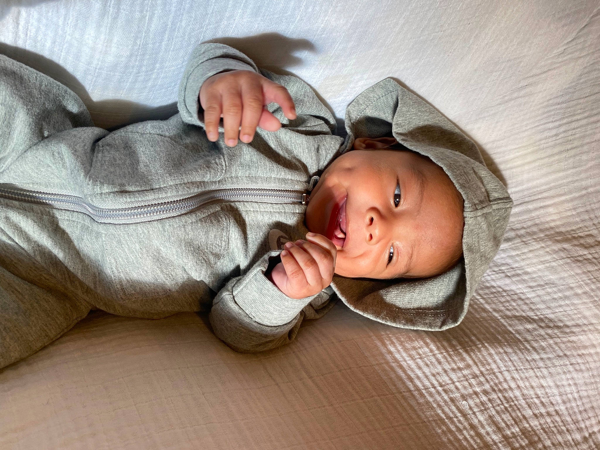 Adriel is registered to the contest to win money with this photo: arm, baby, baby_products, baby_safety, baby_sleeping, baby_toddler_clothing, child, comfort, eye, eyelash, fashion_accessory, flooring, gesture, hand, hat, headwear, linens, nap, person, room