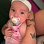 Rose a rejoint le concours — aidez-le/la à gagner de superbes lots ! baby, headband, pacifier, tattoo, butterfly_tattoo, arm, couch, pink_clothing, child, indoor, person, hand, cute, infant, sitting, holding, relaxing, skin, furniture, comfort
