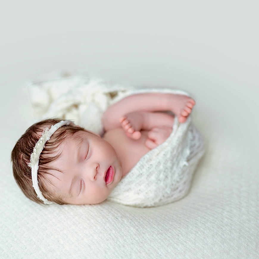 Ariha is registered to the contest to win money with this photo: baby, blanket, bonnet, cap, clothing, face, happy, hat, head, newborn, person, photography, portrait, sleeping, smile