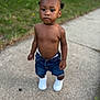Azarion is registered to the contest to win money with this photo: toddler, child, shirtless, denim_shorts, white_sneakers, sidewalk, outdoor, grass, greenery, curious, serious_expression, short_hair, summer, walking, person, young_child, casual, daylight, nature, portrait