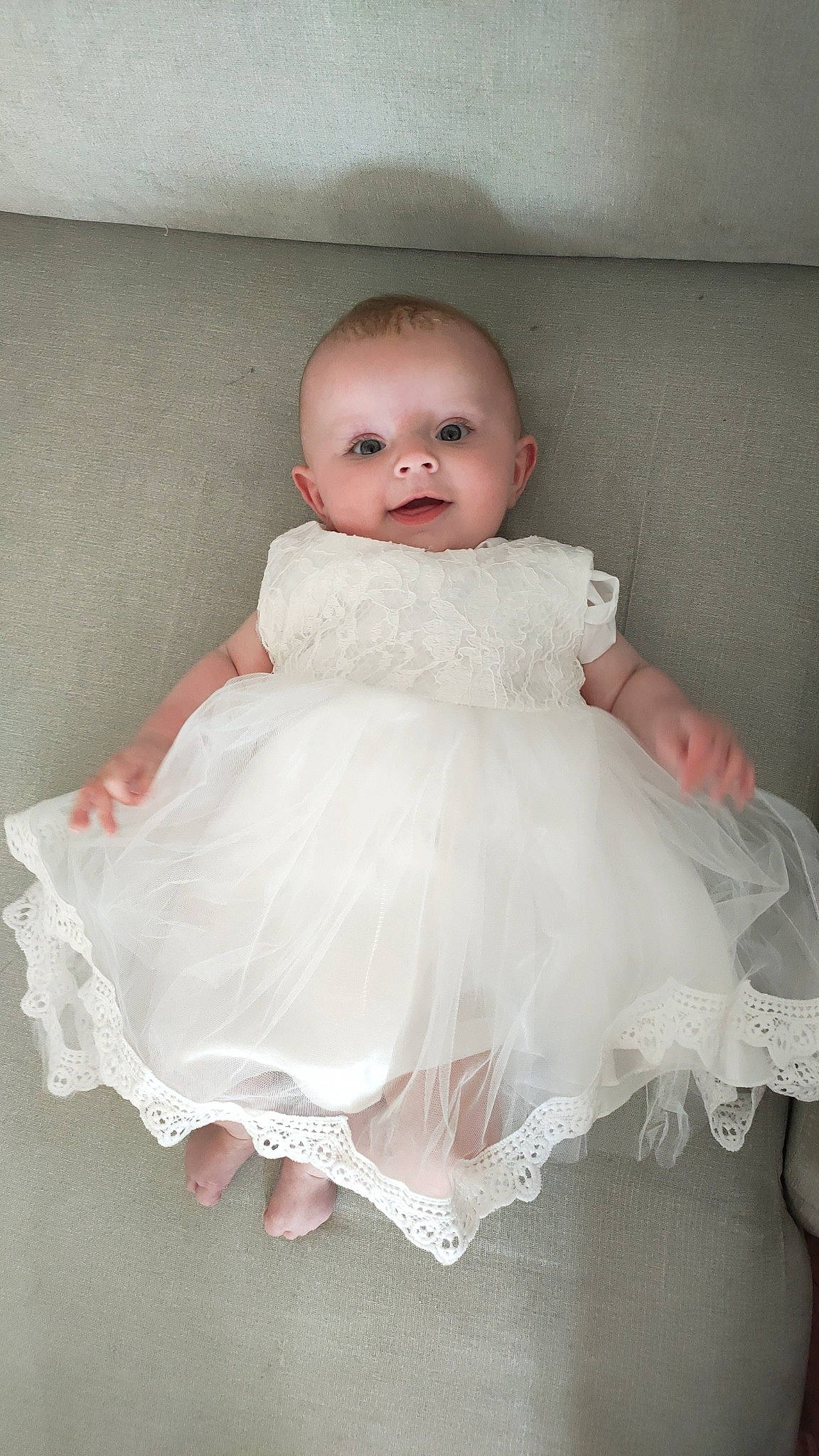 Paola participe au concours pour gagner de l'argent avec cette photo : baby_toddler_clothing, bridal_accessory, day_dress, dress, embellishment, eye, face, flash_photography, happy, head, headgear, human_body, iris, neck, one_piece_garment, person, pink, shoulder, sleeve, smile