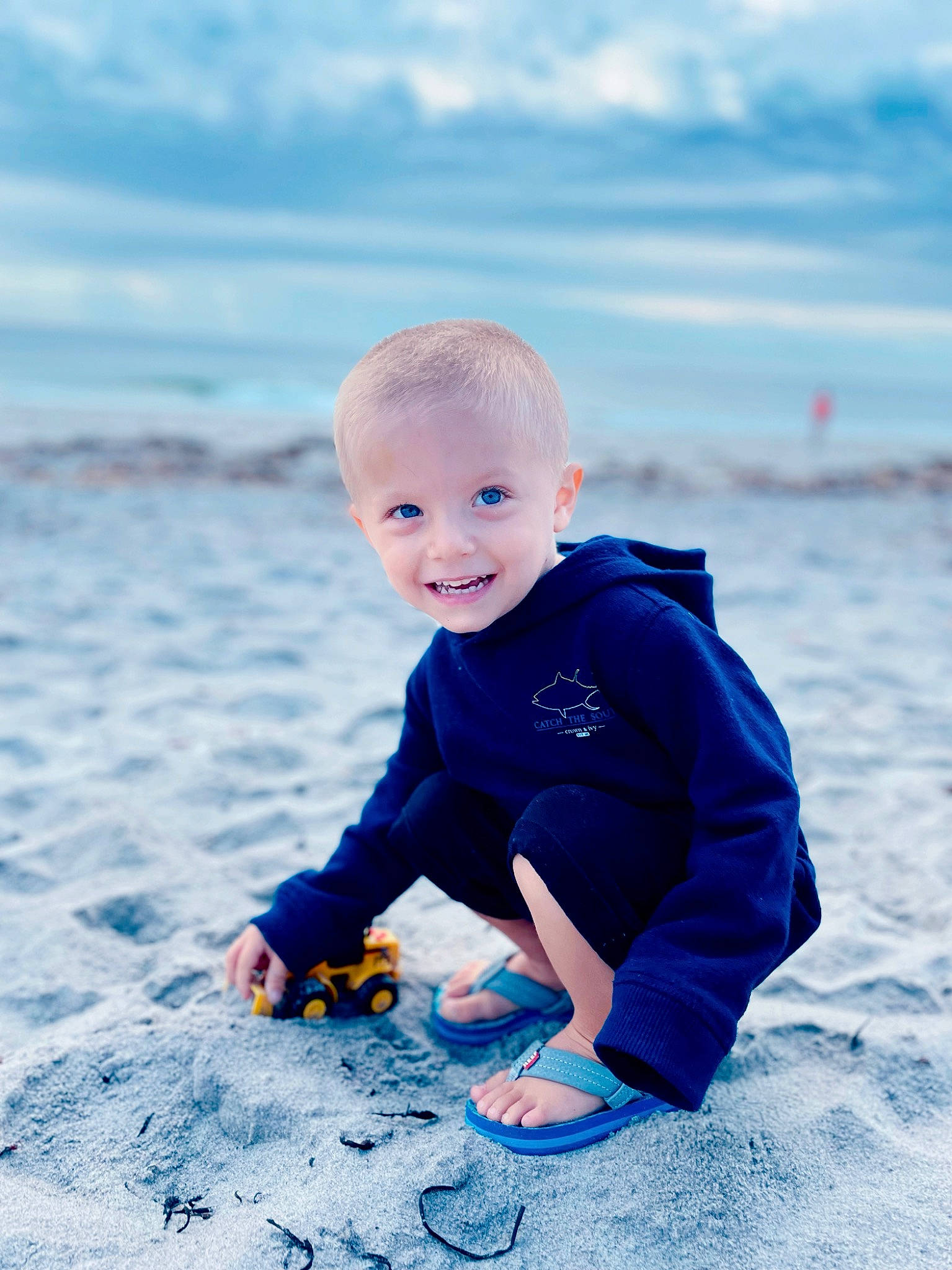 Cornelia is registered to the contest to win money with this photo: azure, baby, baby_toddler_clothing, beach, child, cloud, electric_blue, flash_photography, fun, grass, happy, horizon, joy, leisure, people_in_nature, person, recreation, sand, sky, smile