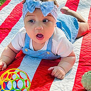 Mia joined the competition — help win amazing prizes! baby, blue_bow, child, curious, cute, expression, face, grass, headband, infant, outdoor, overalls, playing, quilt, red_stripes, summer, toddler, toy_ball, white_shirt, white_stripes