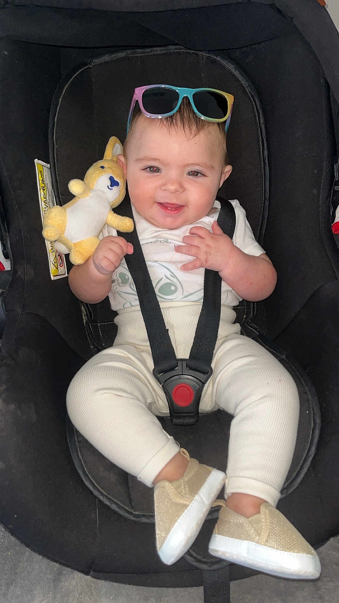 Kélyana participe au concours pour gagner de l'argent avec cette photo : baby, child, car_seat, sunglasses, plush_toy, smiling, happy, infant, clothing, shoes, seatbelt, cute, indoors, person, young_child, fashion, accessory, sitting, playful, adorable