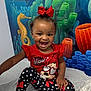Elyana joined the competition — help win amazing prizes! toddler, child, smiling, red_bow, minnie_mouse, polka_dot, leggings, white_sock, medical_table, underwater_mural, seahorse, coral, blue_background, orange_coral, green_coral, happy, indoor, cute, portrait, playful