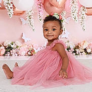 Elyana is registered to the contest to win money with this photo: toddler, child, pink_dress, flower_crown, balloons, butterflies, flowers, smiling, portrait, cute, baby, sitting, decorations, indoor, celebration, happy, headwear, skin, person, studio