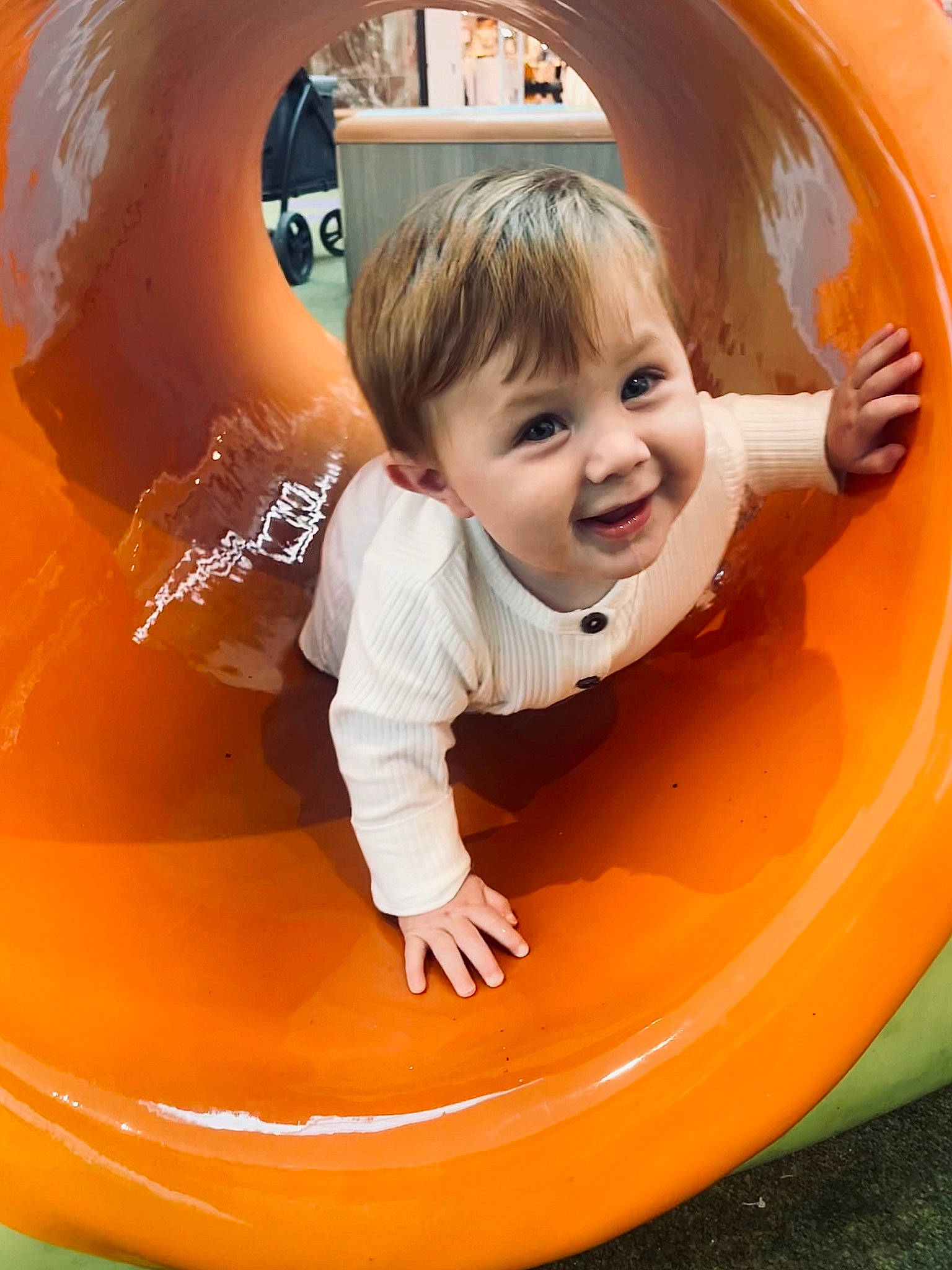 Brooks is registered to the contest to win money with this photo: auto_part, automotive_exterior, baby, baby_toddler_clothing, child, circle, facial_expression, fun, happy, joy, leisure, motor_vehicle, outdoor_play_equipment, oval, person, play, playground, recreation, smile, tire