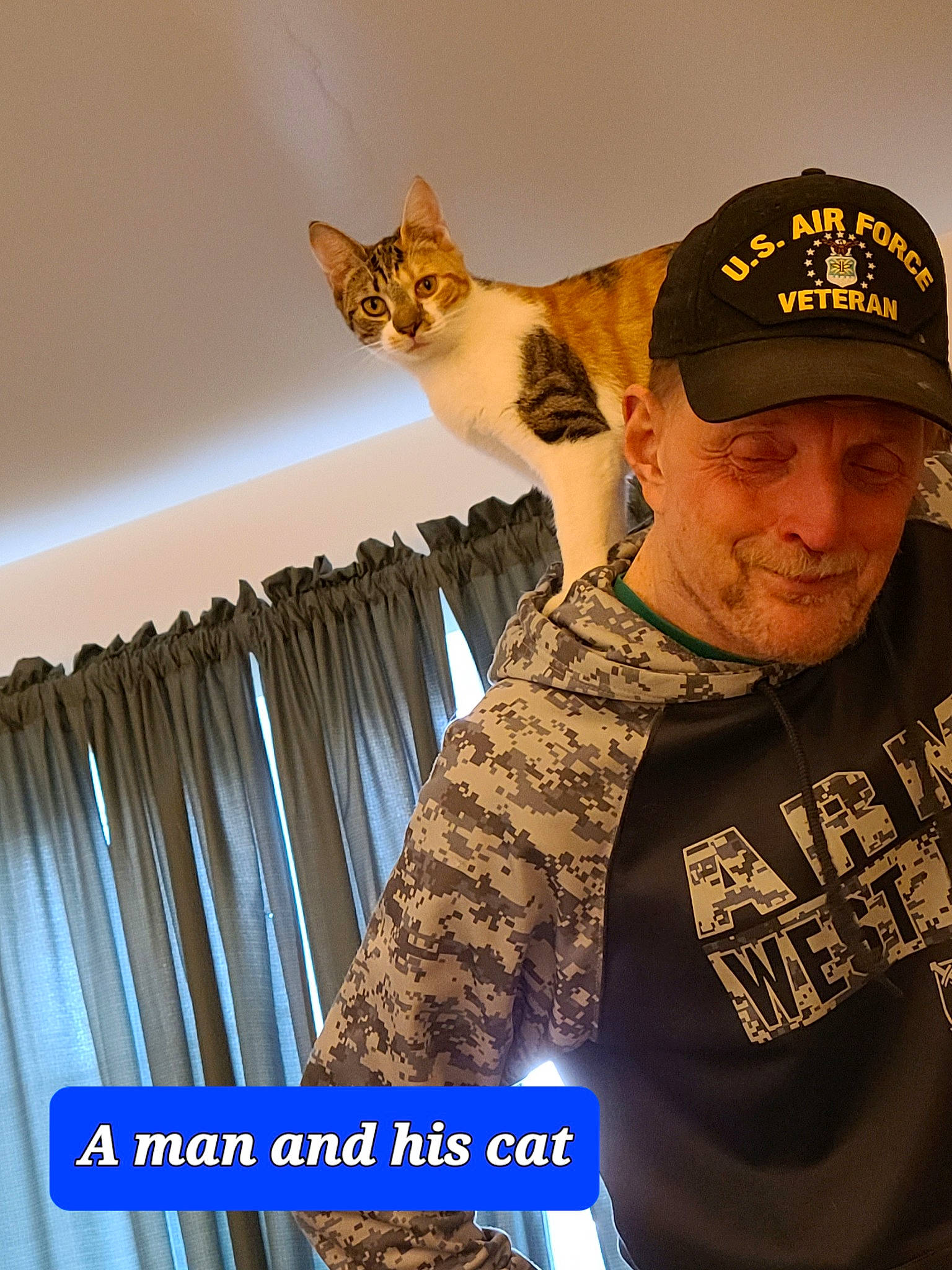 Peeps is registered to the contest to win money with this photo: arm, baseball_cap, cap, cat, curtain, eyewear, fashion_accessory, felidae, formal_wear, fun, fur, gesture, hat, logo, moustache, sleeve, smile, t_shirt, top, uniform