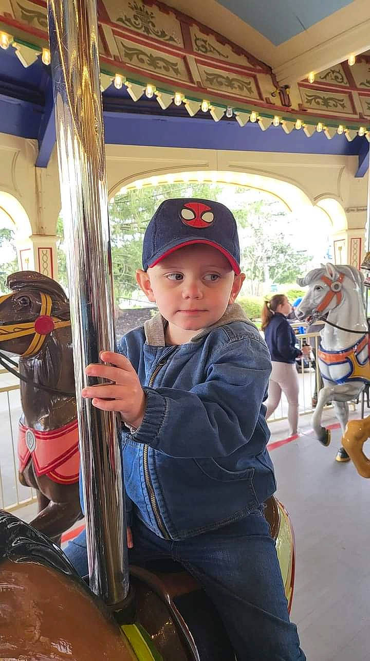 Bennett joined the competition — help win amazing prizes! amusement_park, amusement_ride, bridle, cap, carousel, child, fun, headgear, headwear, horse, horse_supplies, horse_tack, leisure, nonbuilding_structure, person, recreation, rein, toddler, travel, tree