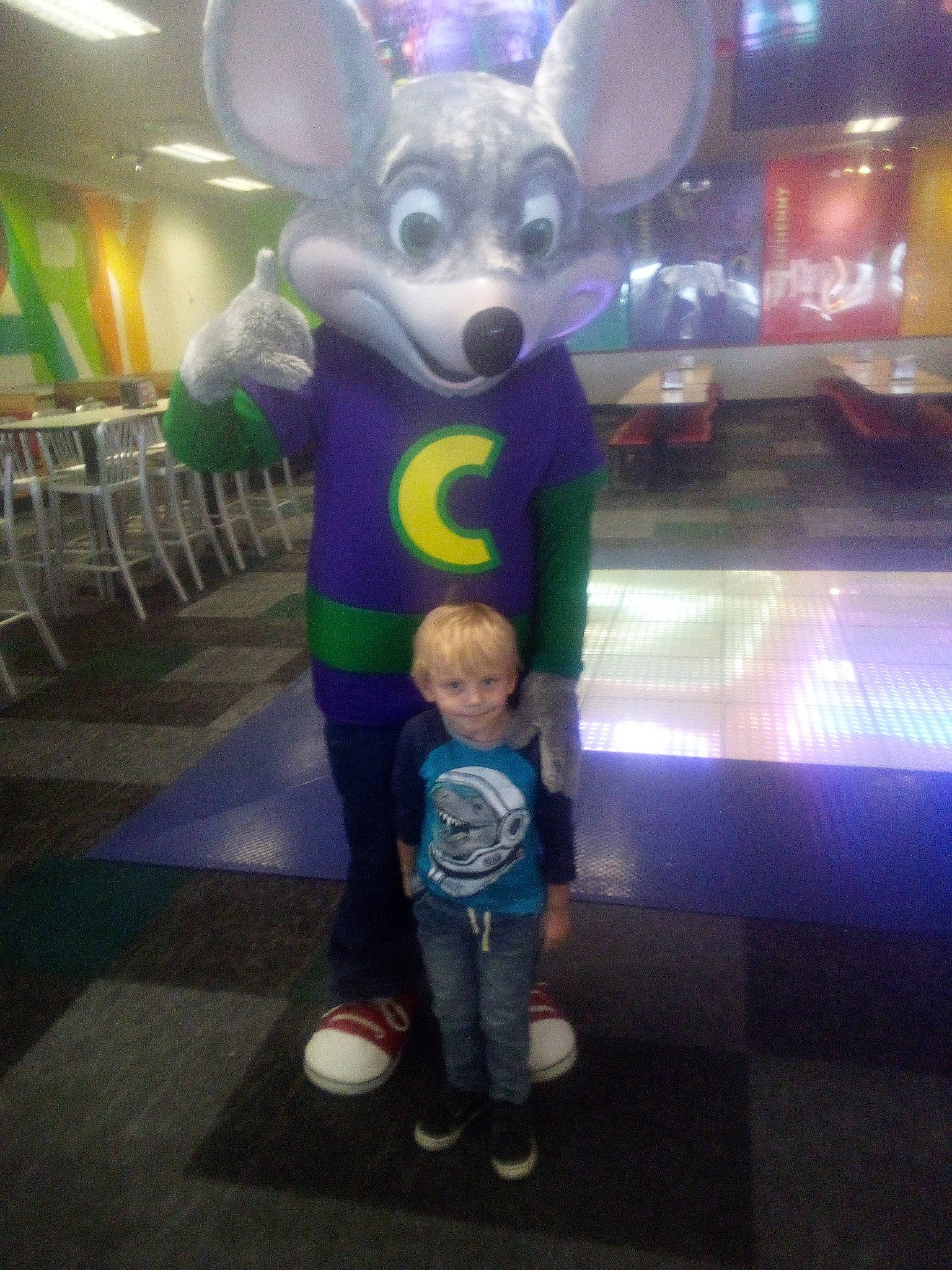 Bennett is registered to the contest to win money with this photo: baby, costume, event, fictional_character, flooring, fun, fur, games, joy, leisure, lighting, magenta, metal, person, purple, recreation, room, t_shirt, toddler, tourist_attraction