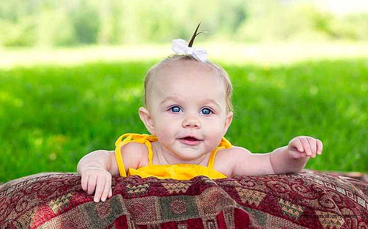 Carlee is registered to the contest to win money with this photo: baby, child, child_model, ear, grass, happy, person, photography, portrait_photography, sitting, skin, smile, toddler, yellow