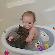 Tommus joined the competition — help win amazing prizes! baby, child, toddler, bathtub, bath_time, kitten, cat, pet, cuddling, smiling, indoor, water, bath_toys, rubber_duck, shampoo, portrait, sitting, playful, cute, household