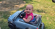 Izzahbella joined the competition — help win amazing prizes! baby, child, toddler, smiling, outdoor, backyard, ride_on_toy, toy_car, jeep, steering_wheel, pink_shirt, denim, grass, playground, slide, kiddie_pool, sunlight, summer, vehicle, portrait