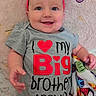 Izzahbella is registered to the contest to win money with this photo: baby, child, infant, smiling, happy, portrait, close_up, pink_headband, bow, gray_onesie, text_on_clothing, big_brother, blanket, colorful, lying_down, indoors, nursery, face, eyes, candid