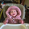 Izzahbella joined the competition — help win amazing prizes! baby, child, infant, smiling, happy, portrait, high_chair, pink_coat, hood, winter_clothing, indoor, home, seated, face, hands, toys, furniture, nursery, photograph, joy