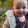 baby, blue_eyes, bunny, child, close_up, clothing, cuddling, face, garden, greenery, happy, infant, jacket, nature, outdoors, plush_toy, polka_dot, portrait, smiling, stuffed_animal