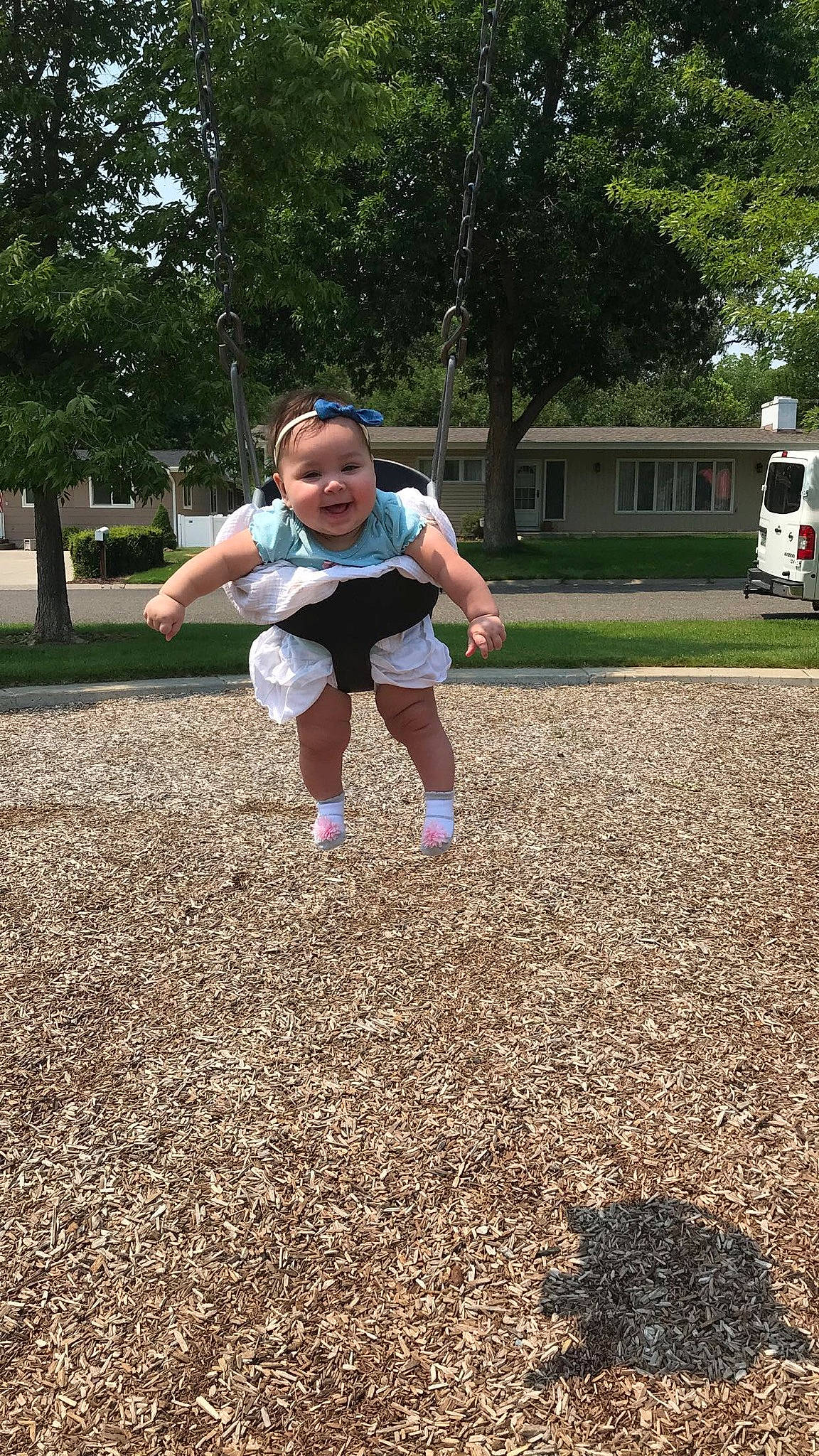 Ayana is registered to the contest to win money with this photo: asphalt, child, city, fun, grass, hat, joy, landscape, leisure, light_commercial_vehicle, outdoor_play_equipment, people_in_nature, person, plant, recreation, shorts, soil, t_shirt, toddler, tree