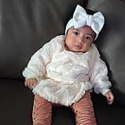 Itzel joined the competition — help win amazing prizes! baby, infant, child, headband, bow, white_sweater, pink_leggings, sitting, couch, leather, indoor, portrait, cute, young_child, fashion, cozy, feet, hands, looking_at_camera, soft_texture