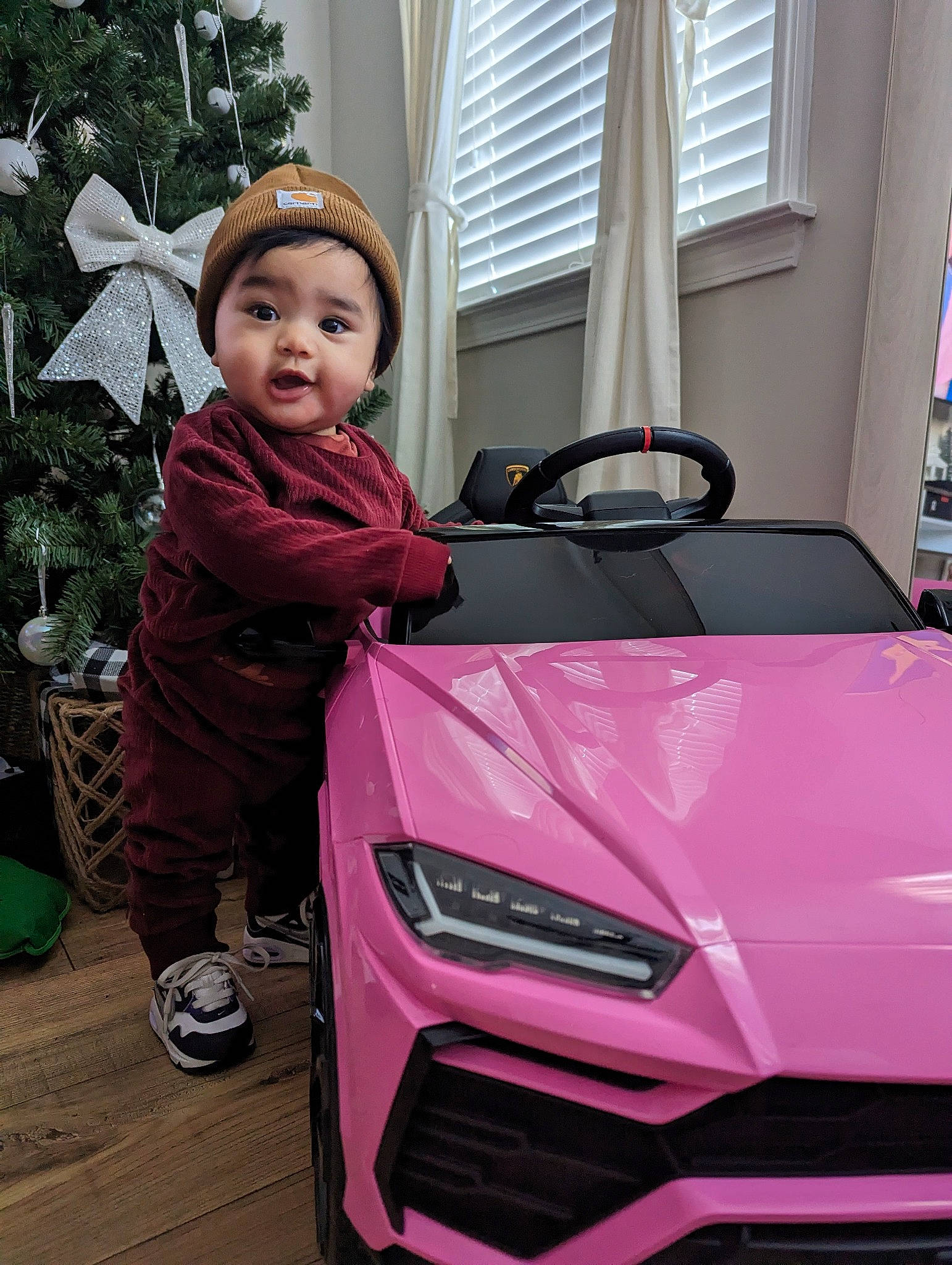 Reylynne Rose is registered to the contest to win money with this photo: alloy_wheel, automotive_design, automotive_exterior, automotive_lighting, automotive_tire, bumper, fender, flowerpot, grille, headlamp, headwear, hood, motor_vehicle, person, personal_luxury_car, pink, purple, rim, tire, toddler