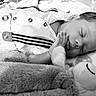 Charles joined the competition — help win amazing prizes! baby, sleeping, infant, plush_toy, soft, cute, hand, face, peaceful, clothing, striped_suspender, monochrome, portrait, lying_down, child, newborn, bed, blanket, resting, close_up