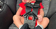 Charles joined the competition — help win amazing prizes! baby, newborn, car_seat, sleeping, hat, red_clothing, black_socks, infant, child, safety_harness, seatbelt, toddler, portrait, cute, indoors, resting, small_person, one_person, infant_clothing, peaceful