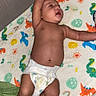 Charles joined the competition — help win amazing prizes! baby, infant, diaper, crib, blanket, dinosaur_pattern, cute, child, sleeping_area, stretching, skin, foot, hand, mesh_crib, soft_texture, colorful, lying_down, indoors, young_child, resting
