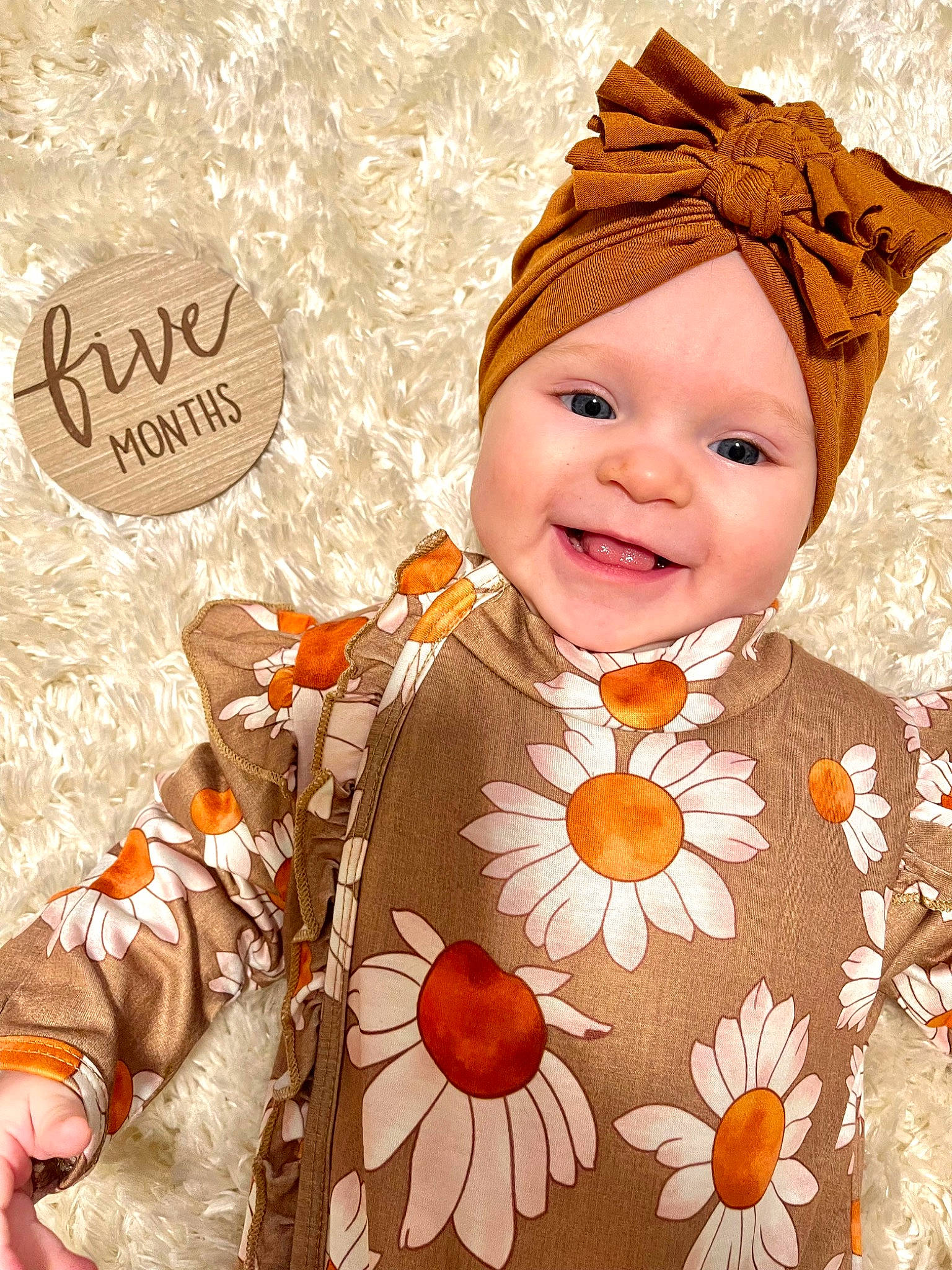 Averi is registered to the contest to win money with this photo: baby, baby_products, baby_toddler_clothing, child, costume_accessory, costume_hat, event, face, font, happy, headwear, joy, laugh, orange, outerwear, pattern, peach, person, petal, portrait_photography