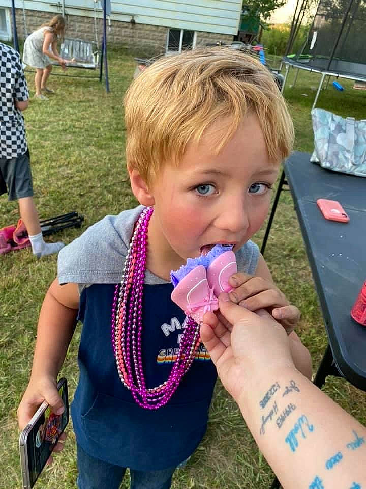 Kameron is registered to the contest to win money with this photo: child, drinking, event, fun, grass, happy, ice_cream_cone, leisure, liquid_bubble, nail, person, pink, plant, play, recreation, shorts, t_shirt, thumb, toddler, vacation