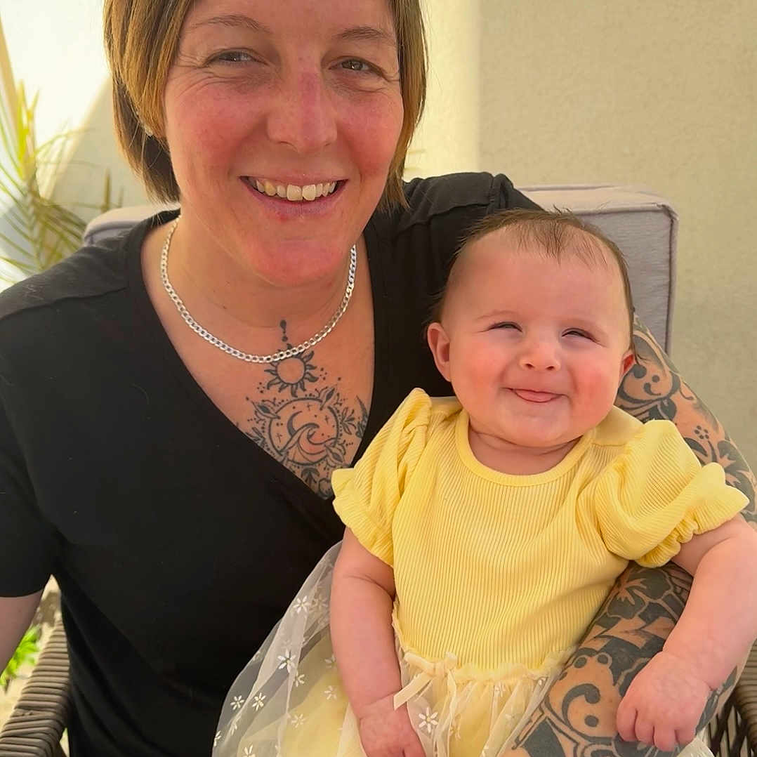 Riley is registered to the contest to win money with this photo: accessories, baby, blouse, bracelet, clothing, dress, earring, face, glasses, happy, head, jewelry, necklace, newborn, person, photography, portrait, skin, t_shirt, tattoo