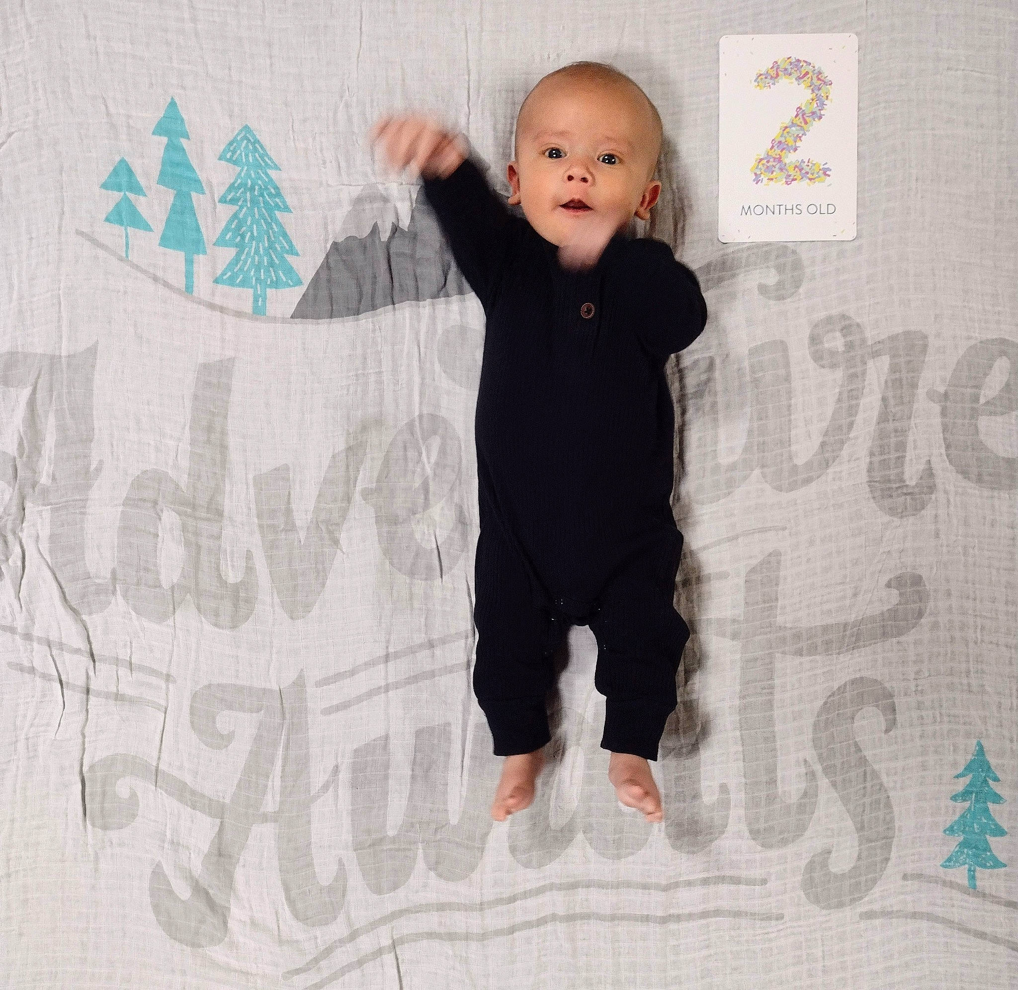 Leonard is registered to the contest to win money with this photo: baby, baby_toddler_clothing, cheek, comfort, eye, finger, flooring, font, gesture, happy, human_body, logo, long_sleeved_t_shirt, pattern, person, room, sleeve, t_shirt, thumb, toddler