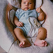 Mateo joined the competition — help win amazing prizes! baby, infant, baby_chair, onesie, plush, furniture, floor_tile, face, expression, indoors, child, baby_feet, baby_hands, safety_harness, cozy, portrait, cute, home, relaxing, text_overlay
