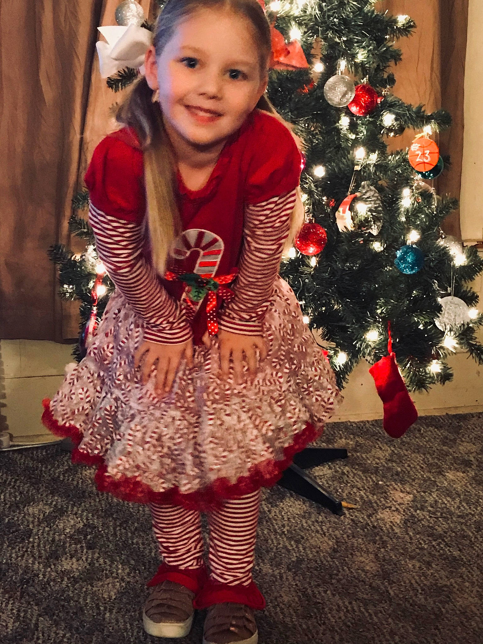 Aleigha joined the competition — help win amazing prizes! child, child_model, christmas, christmas_decoration, christmas_eve, christmas_ornament, christmas_tree, dress, event, fir, holiday, interior_design, joy, person, smile, toddler, tree