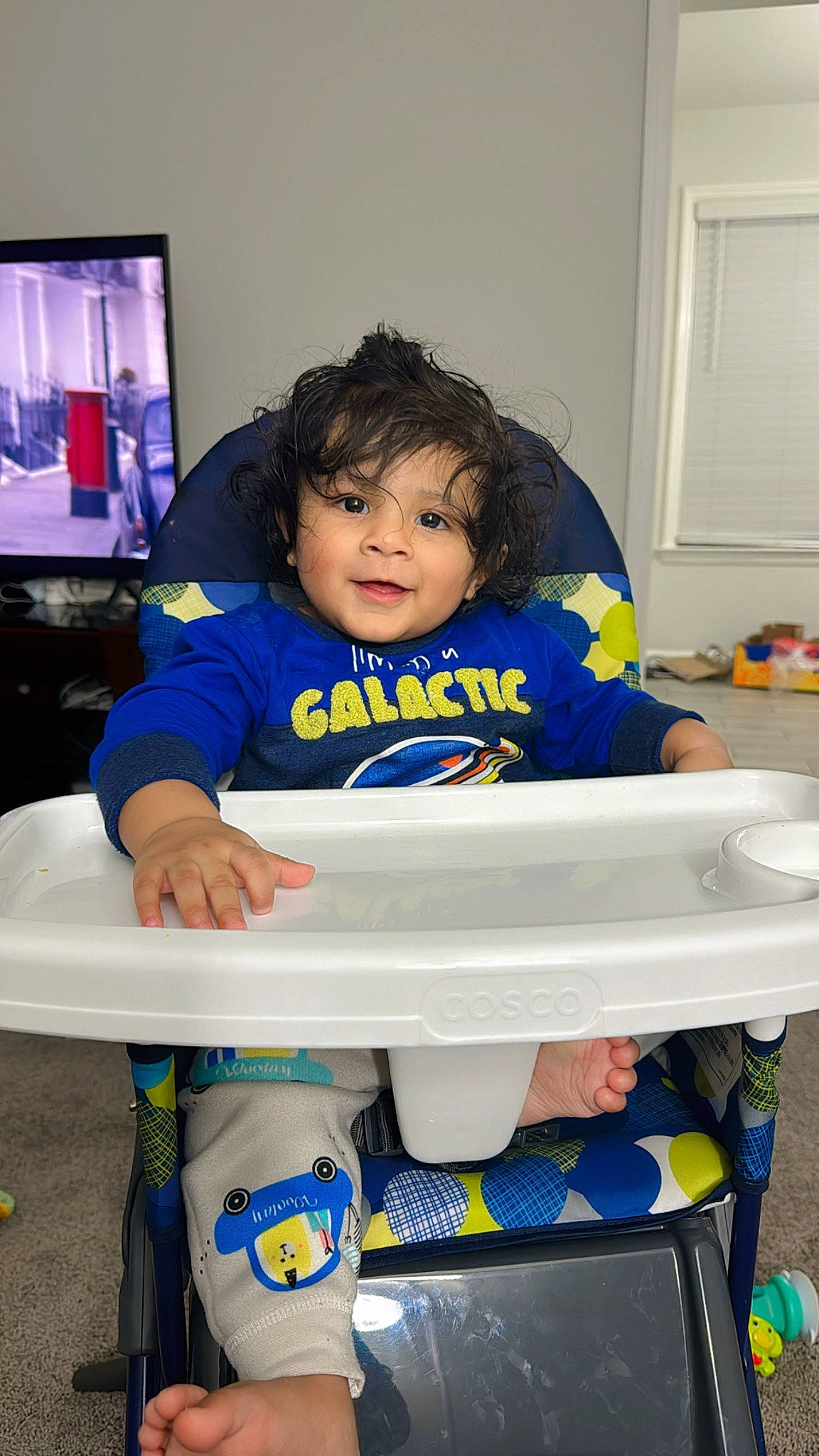 Reyansh is registered to the contest to win money with this photo: baby, baby_toddler_clothing, cart, child, computer_monitor, display_device, door, electric_blue, fun, happy, led_backlit_lcd_display, person, plastic, play, room, sitting, t_shirt, television, toddler, toy