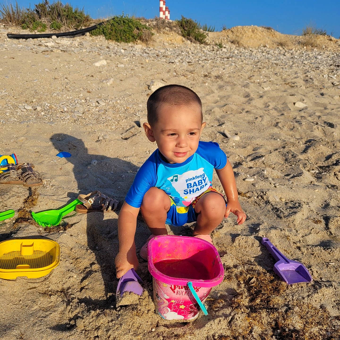 José participe au concours pour gagner de l'argent avec cette photo : beach, bucket, child, fun, happy, joy, landscape, leisure, people_in_nature, person, play, recreation, sand, shorts, shovel, sky, sneakers, soil, summer, t_shirt