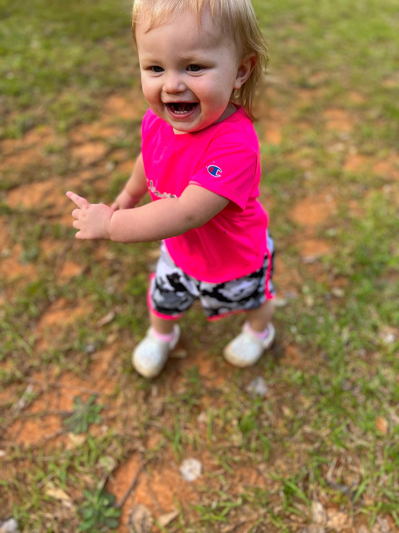Emilee is registered to the contest to win money with this photo: baby, baby_toddler_clothing, child, eye, face, fun, grass, grassland, happy, head, leg, leisure, magenta, people_in_nature, person, plant, shorts, sleeve, smile, t_shirt