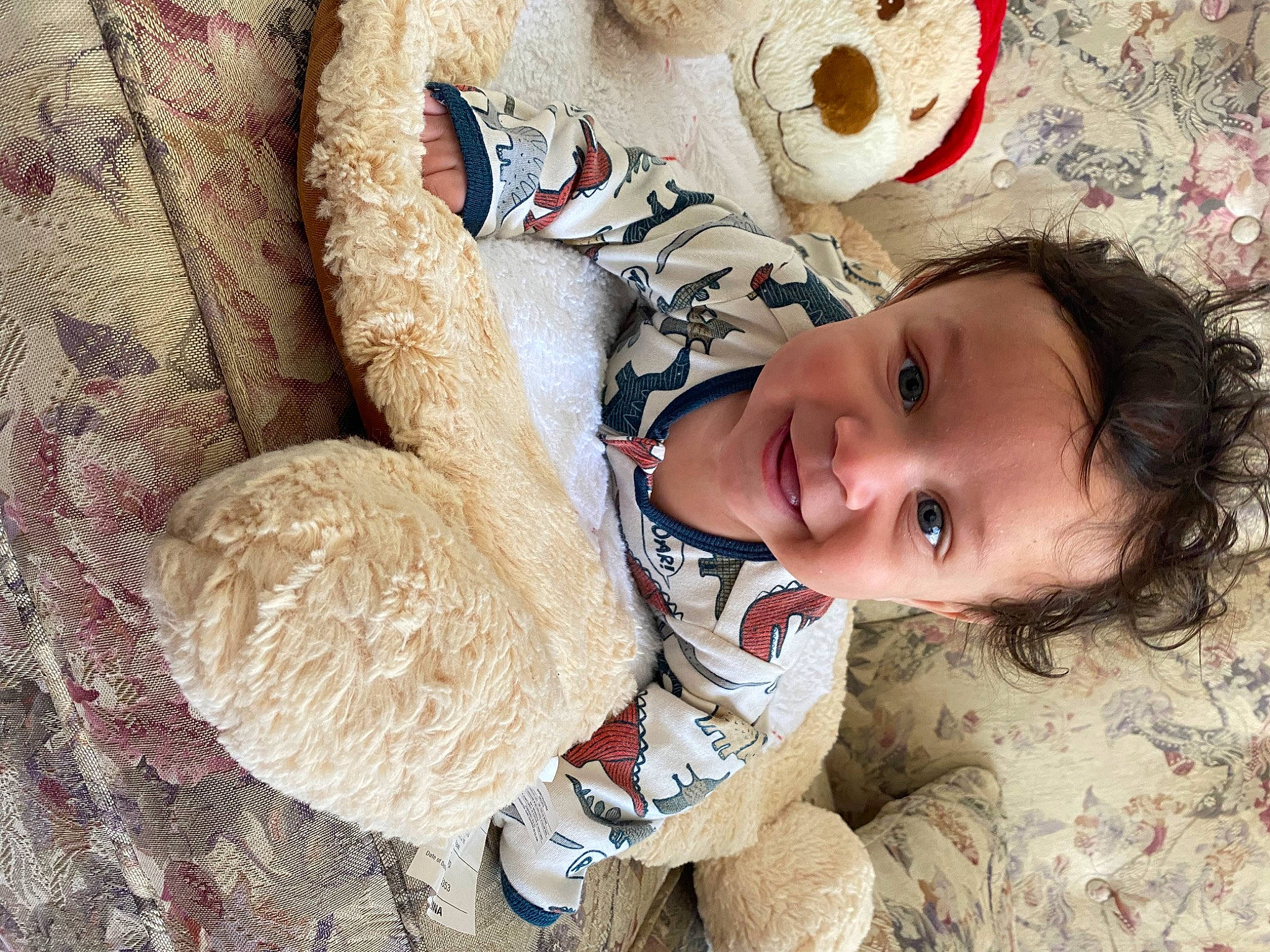 Gregory is registered to the contest to win money with this photo: baby, baby_toddler_clothing, child, comfort, eye, facial_expression, fawn, happy, hat, head, joy, nose, pattern, people_in_nature, person, skin, smile, textile, toddler, toy