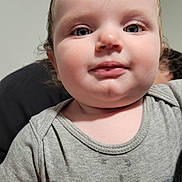 Scarlett joined the competition — help win amazing prizes! toddler, child, face, portrait, closeup, grey_tshirt, pirate_logo, skull, red, black, curly_hair, indoor, cute, baby, person, smile, cheeks, eyes, head, casual_clothing
