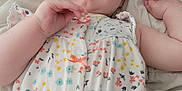 Scarlett joined the competition — help win amazing prizes! baby, infant, child, face, blanket, clothing, onesie, floral_pattern, lying_down, soft, cute, pink, blue, yellow, white, hand, skin, portrait, indoors, sleepwear