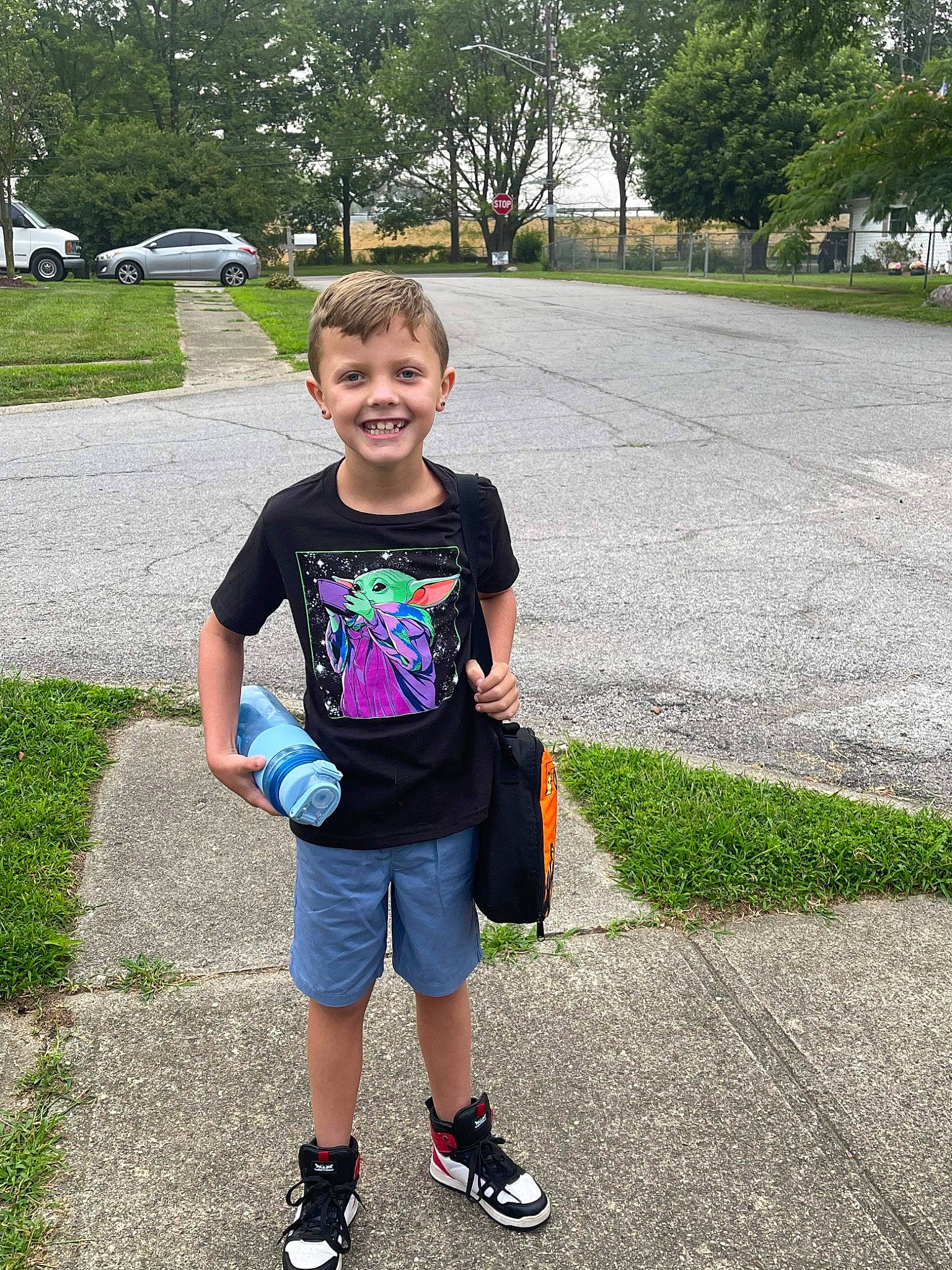 Kanen is registered to the contest to win money with this photo: asphalt, car, child, electric_blue, fun, grass, hairstyle, joy, leg, leisure, outdoor_recreation, person, plant, play, recreation, road, shorts, smile, t_shirt, toddler