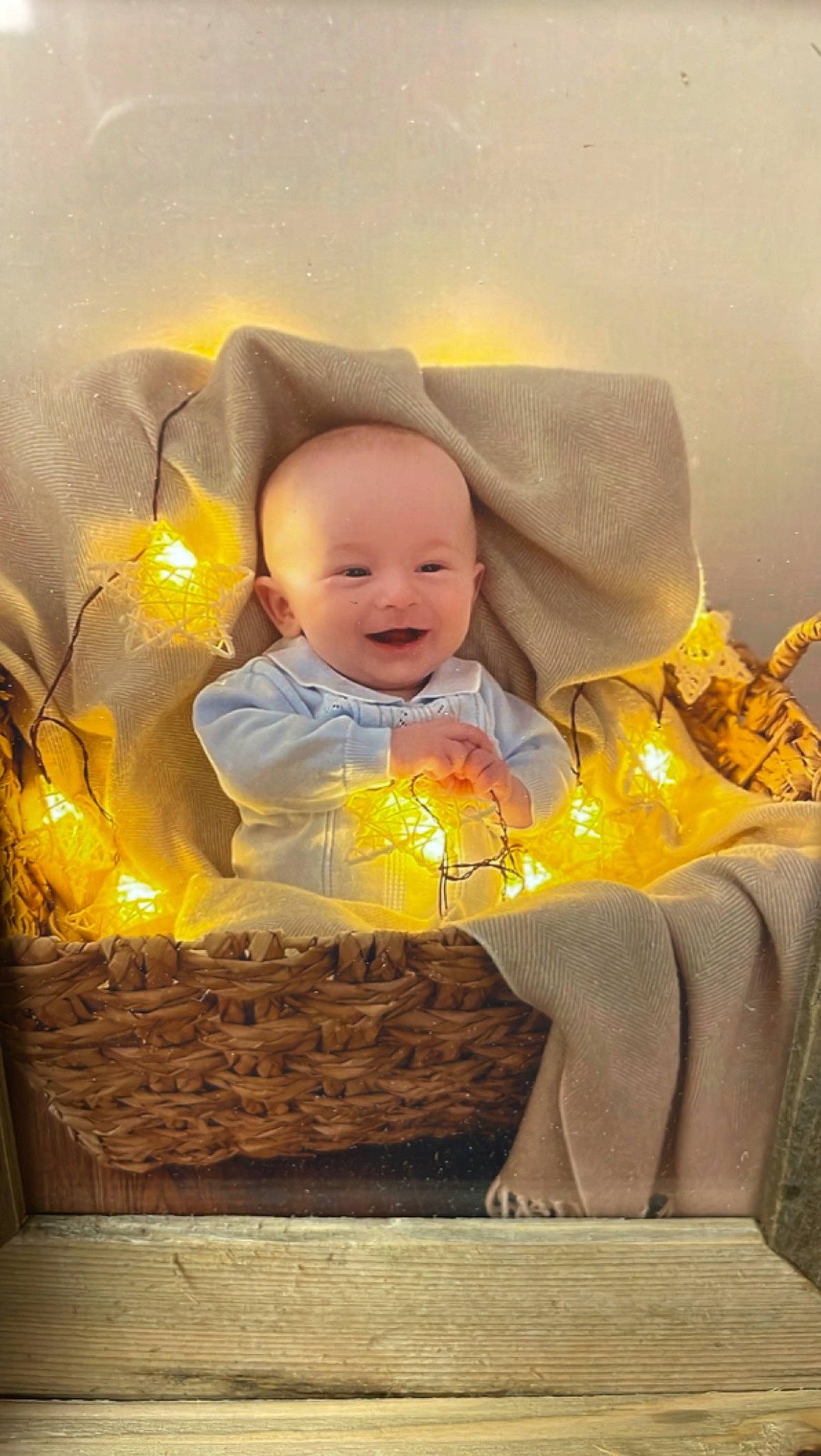 Luke is registered to the contest to win money with this photo: baby, candle, child, christmas_eve, cloud, comfort, facial_expression, happy, home_accessories, illustration, interior_design, lighting_accessory, linens, orange, person, room, sitting, smile, toddler, tree