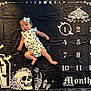baby, infant, romper, headband, bow, monthly_milestone, blanket, skull, bats, coffin, numbers, months, black_background, white_print, flowers, crystals, gothic_theme, cute, surprised, lying_down