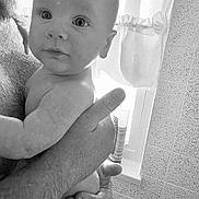 Fred joined the competition — help win amazing prizes! baby, infant, person, adult_hand, skin, face, portrait, black_and_white, window, curtain, texture, indoor, holding, closeup, expression, child, human, arm, fingers, naked