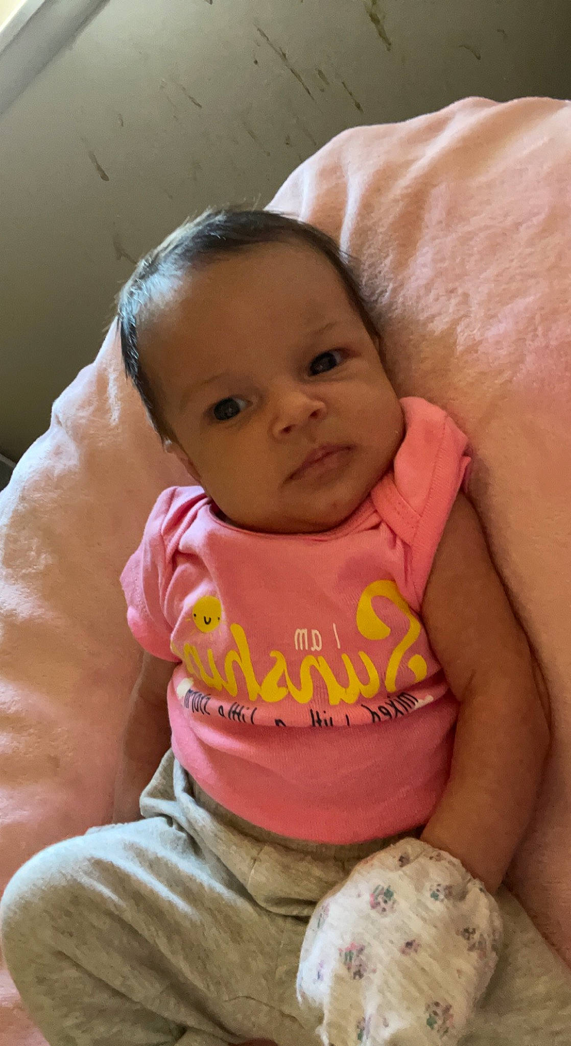 Avaeya is registered to the contest to win money with this photo: abdomen, baby, baby_products, baby_toddler_clothing, cheek, child, comfort, eye, finger, happy, iris, linens, lip, mammal, mouth, nose, person, pink, sitting, skin