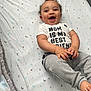 Jayce joined the competition — help win amazing prizes! baby, child, smiling, happy, lying_down, bed, sheet, stars, moon, clothing, tshirt, pants, infant, cute, face, hands, barefoot, indoor, person, joy