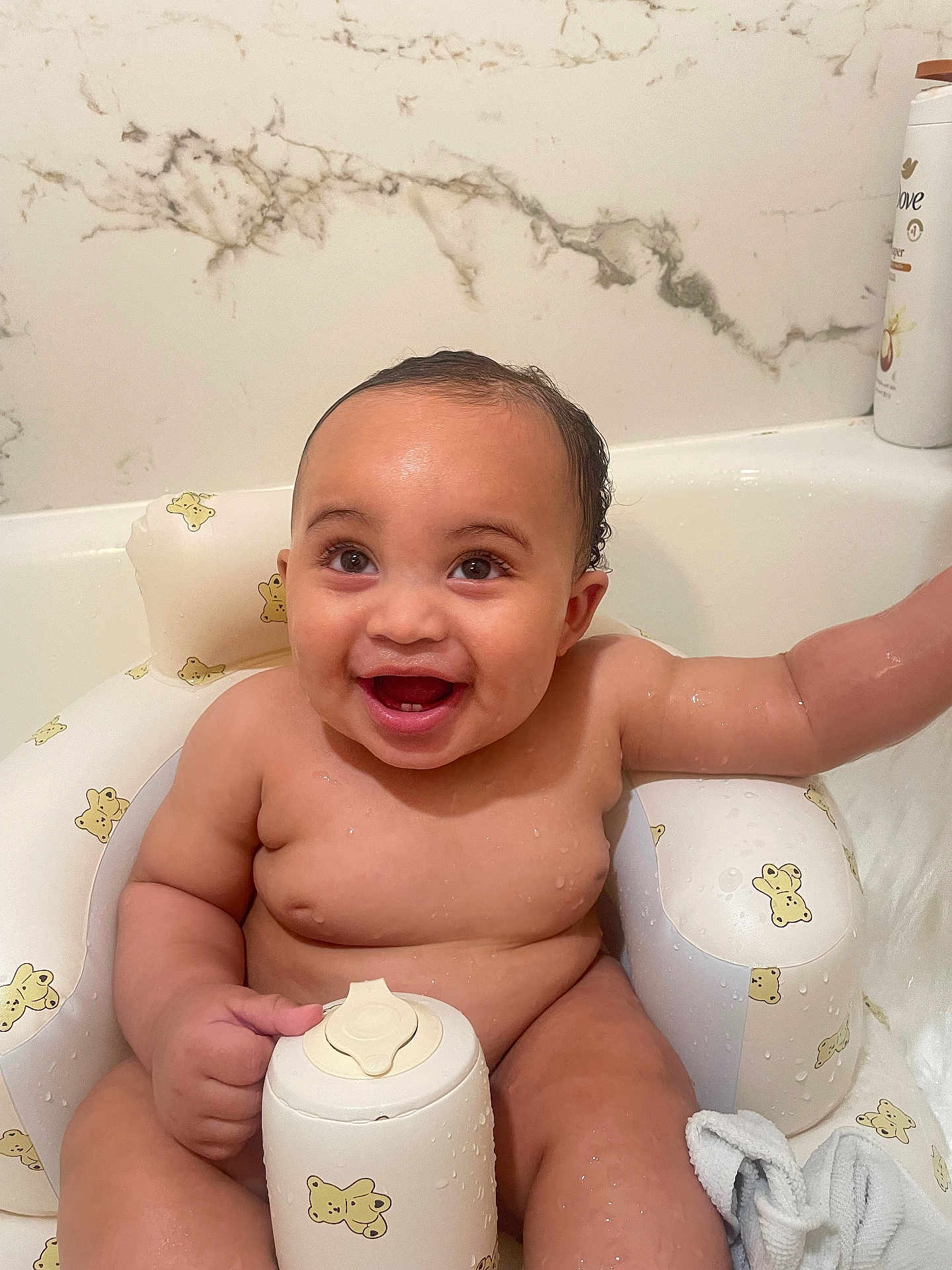 Jayce is registered to the contest to win money with this photo: baby, bath, bathroom, bathtub, bear_prints, child, cute, happy, infant, inflatable_chair, lotion_bottle, marble_wall, naked, sitting, skin, smiling, toy, water_drops, wet_hair, white_bottle