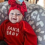 baby, smile, red_clothing, headband, bow, blanket, indoor, happy, infant, face, sweater, child, cute, holiday, portrait, cozy, person, apparel, pattern, soft