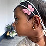 Nila participe au concours pour gagner de l'argent avec cette photo : child, side_profile, headband, flower, earring, sweater, knitted, portrait, young_child, face, hair, ear, indoors, decor, plant, flowerpot, background_blur, cute, fashion, skin