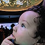 toddler, child, face, profile, curly_hair, blue_eyes, hand, finger, aquarium, fish, ceiling, glow, light, indoor, people, silhouette, sweater, portrait, contemplative, baby
